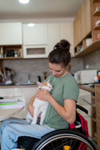 istock Loving disabled woman stroking her cat at home. 1766813035