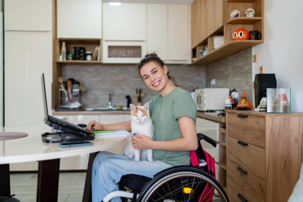 istock Happy disabled freelancer enjoying with her cat at home office. 1766815203