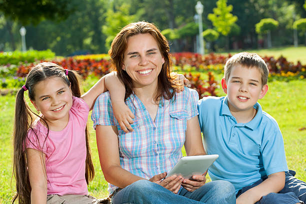 istock Happy Family using laptop lying on grass 176681684