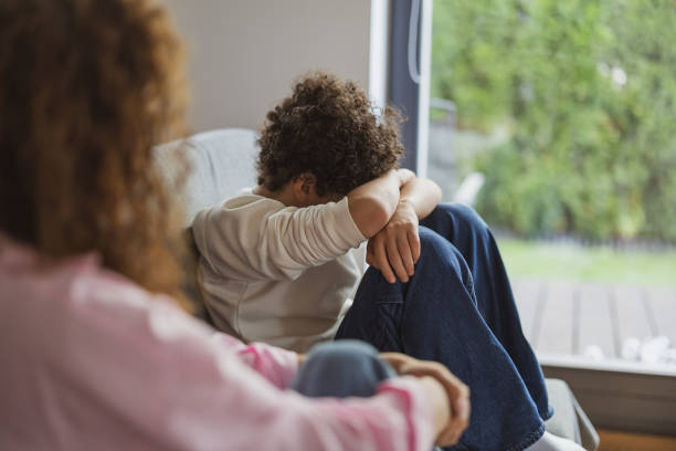 istock Upset boy sitting on sofa while his mother looking at him 1766816877