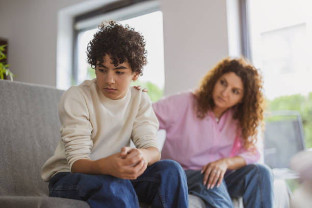 istock Upset boy sitting on sofa while his mother looking at him 1766816890