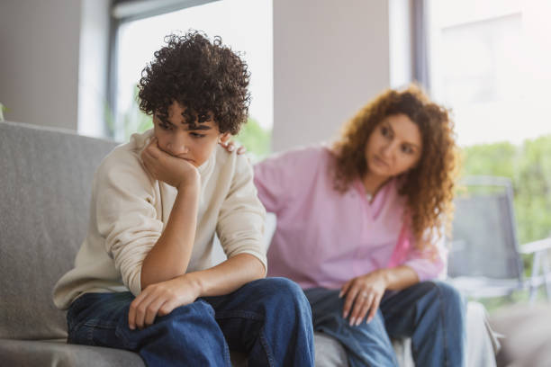 istock Upset boy sitting on sofa while his mother looking at him 1766816891