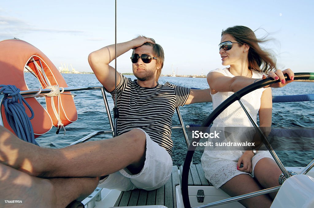 Happy young couple relaxing on a yacht Adult Stock Photo