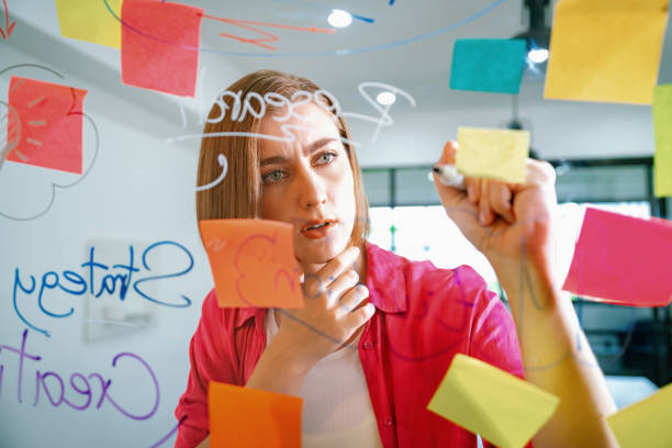 istock Young beautiful business leader writing marketing idea on board. Immaculate. 1766821360
