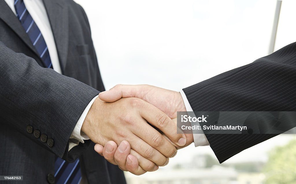 Male handshake Male handshake on business background Adult Stock Photo