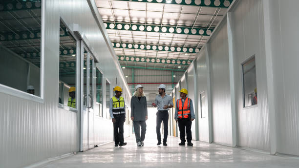 istock Team engineers workers planning and talking in empty warehouse to design the arrangement of product shelves and organize strategy about new manufacturing. 1766839804