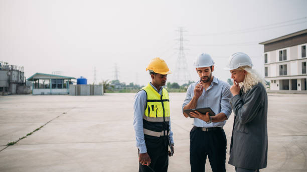 istock Engineer talks with the team to plan the factory setup. Professionals working planning and talking to design the arrangement of warehouse. 1766849331