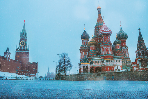 Saint Basil`s cathedral, Spasskaya tower and Red square in Moscow. Winter snowy morning in the historical centre, Russia. Horizontal travel photo of famous place without people