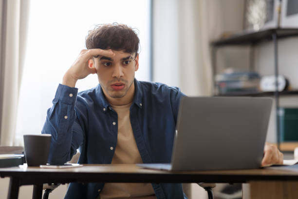 istock Bored Middle Eastern Guy Sitting At Laptop Hating Job Indoors 1766860771