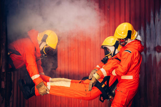istock First Aid Support and Courageous Firefighters Saving People from Workplace Accidents. Fearless Firefighter Heroes Rescuing Lives from Smoke and Fire Hazards. 1766872840