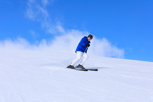 Active lifestyle, Vital senior men snow skier skiing, enjoying on sunny ski resorts. Skiing carving at high speed .
Italian Alps  ski area. Ski resort Livigno. italy, Europe.