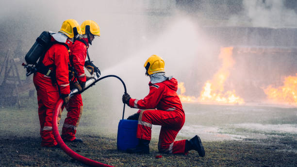 istock Fearless Firefighters Battling Blaze with Water and Extinguishers. Firefighters in Action, Extinguishing Fire with Teamwork and Courage. Intense Firefighting Training Exercise. 1766874983