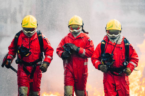 istock Firefighter in Full Protective Gear. Heroic Fireman Combats Intense Blaze with Life-Saving Equipment. 1766876143