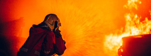 istock Fearless Firefighters Battling Blaze with Water and Extinguishers. Firefighters in Action, Extinguishing Fire with Teamwork and Courage. Intense Firefighting Training Exercise. 1766878848