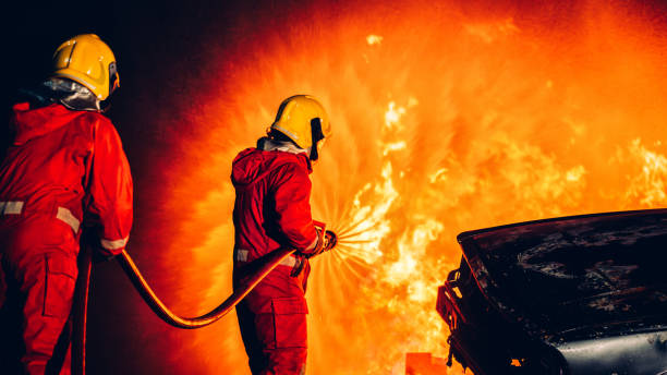 istock Fearless Firefighters Battling Blaze with Water and Extinguishers. Firefighters in Action, Extinguishing Fire with Teamwork and Courage. Intense Firefighting Training Exercise. 1766879414