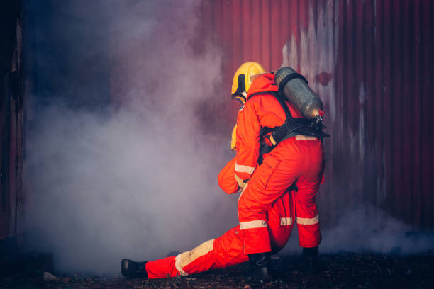istock First Aid Support and Courageous Firefighters Saving People from Workplace Accidents. Fearless Firefighter Heroes Rescuing Lives from Smoke and Fire Hazards. 1766881269