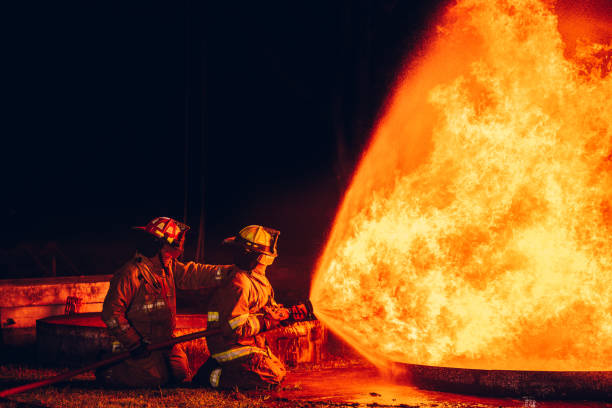 istock Fearless Firefighters Battling Blaze with Water and Extinguishers. Firefighters in Action, Extinguishing Fire with Teamwork and Courage. Intense Firefighting Training Exercise. 1766882905