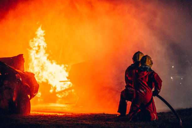 istock Fearless Firefighters Battling Blaze with Water and Extinguishers. Firefighters in Action, Extinguishing Fire with Teamwork and Courage. Intense Firefighting Training Exercise. 1766883975