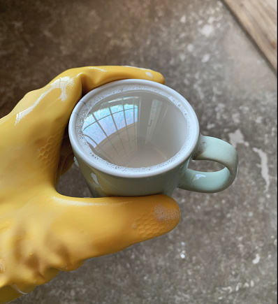 Surface tension creates half a bubble of soap in a coffee cup