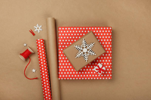 istock Packing Christmas gifts with red paper 1766886253