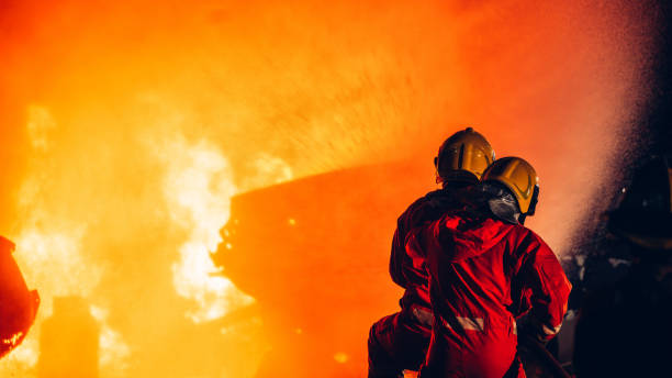 istock Fearless Firefighters Battling Blaze with Water and Extinguishers. Firefighters in Action, Extinguishing Fire with Teamwork and Courage. Intense Firefighting Training Exercise. 1766887877