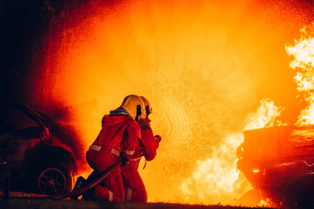 istock Fearless Firefighters Battling Blaze with Water and Extinguishers. Firefighters in Action, Extinguishing Fire with Teamwork and Courage. Intense Firefighting Training Exercise. 1766890138
