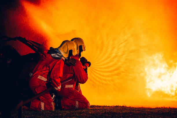 istock Fearless Firefighters Battling Blaze with Water and Extinguishers. Firefighters in Action, Extinguishing Fire with Teamwork and Courage. Intense Firefighting Training Exercise. 1766890168