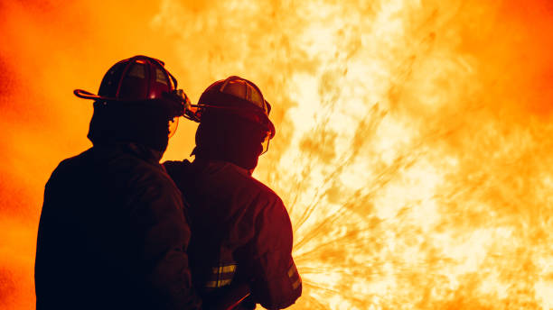 istock Fearless Firefighters Battling Blaze with Water and Extinguishers. Firefighters in Action, Extinguishing Fire with Teamwork and Courage. Intense Firefighting Training Exercise. 1766890744