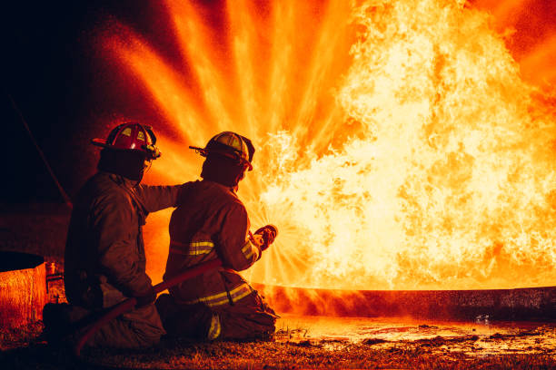 istock Fearless Firefighters Battling Blaze with Water and Extinguishers. Firefighters in Action, Extinguishing Fire with Teamwork and Courage. Intense Firefighting Training Exercise. 1766891296