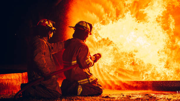 istock Fearless Firefighters Battling Blaze with Water and Extinguishers. Firefighters in Action, Extinguishing Fire with Teamwork and Courage. Intense Firefighting Training Exercise. 1766892417