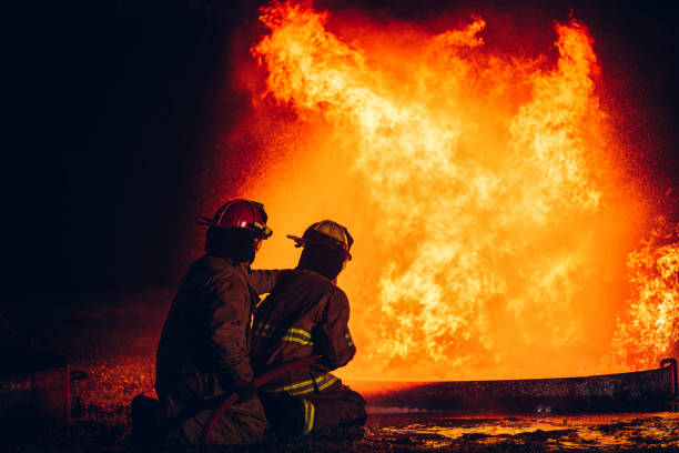 istock Fearless Firefighters Battling Blaze with Water and Extinguishers. Firefighters in Action, Extinguishing Fire with Teamwork and Courage. Intense Firefighting Training Exercise. 1766892957
