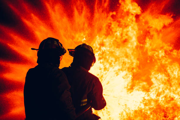 istock Fearless Firefighters Battling Blaze with Water and Extinguishers. Firefighters in Action, Extinguishing Fire with Teamwork and Courage. Intense Firefighting Training Exercise. 1766893138