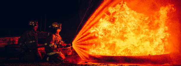 istock Fearless Firefighters Battling Blaze with Water and Extinguishers. Firefighters in Action, Extinguishing Fire with Teamwork and Courage. Intense Firefighting Training Exercise. 1766894019