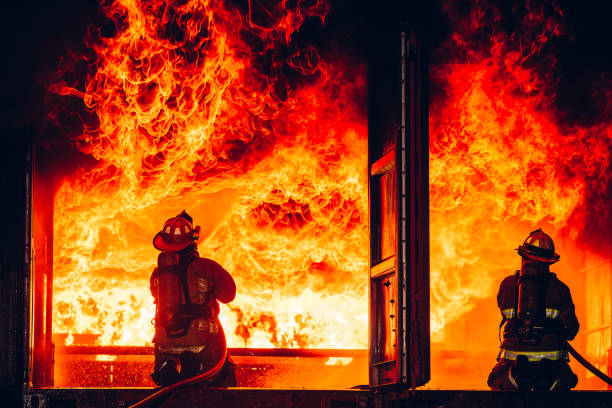 istock Fearless Firefighters Battling Blaze with Water and Extinguishers. Firefighters in Action, Extinguishing Fire with Teamwork and Courage. Intense Firefighting Training Exercise. 1766894044