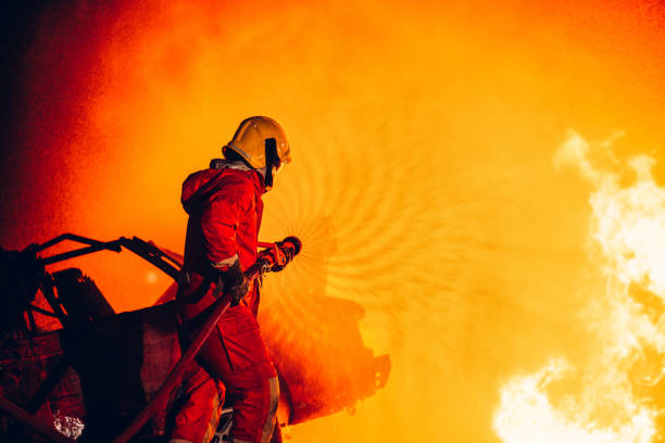 istock Fearless Firefighters Battling Blaze with Water and Extinguishers. Firefighters in Action, Extinguishing Fire with Teamwork and Courage. Intense Firefighting Training Exercise. 1766896748