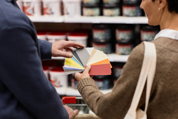 istock Couple choosing paint colors and holding samples in home improvement store 1766904056