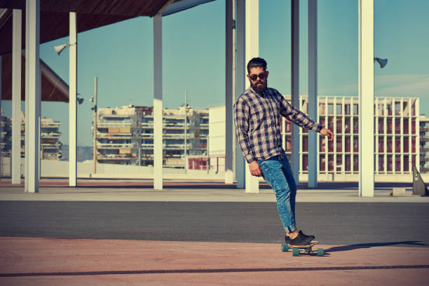 istock Energetic man riding longboard at skate park 1766911979