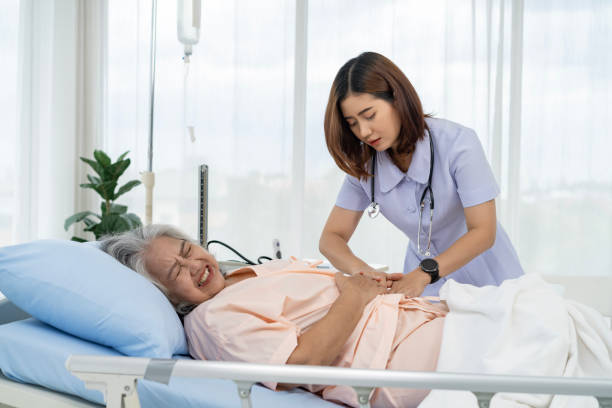 istock A nurse or caregiver for an elderly patient is helping a patient with severe stomach problems 1766913800