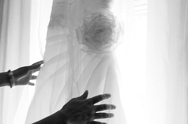 istock Hands with hanging bridal gown 176692198