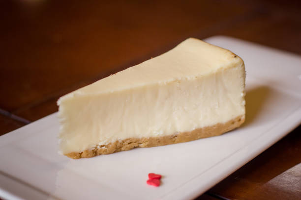 istock Cheesecake on white plate on wooden table. Selective focus. 1766925028