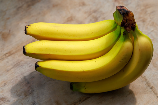 Pair of ripe bananas with brown spots isolated on white background