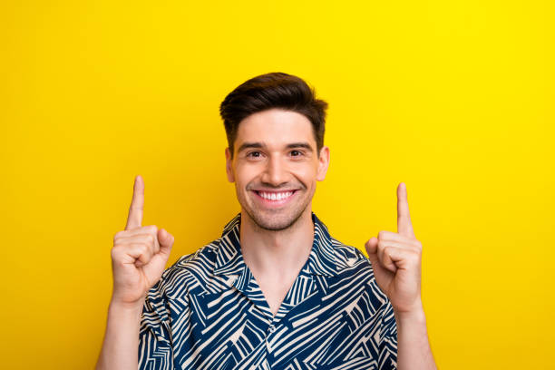 istock Photo of optimistic nice man with bristle dressed blue clothes indicating at proposition empty space isolated on yellow color background 1766930536