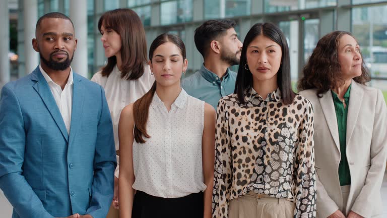 Diversity, group and awkward business people confused together in an office building bored by work or overworked. Bad, annoyed and portrait of corporate employees at the workplace as workforce