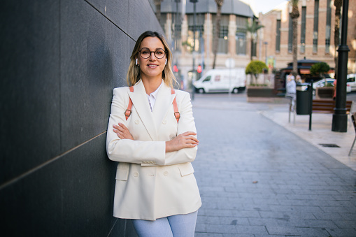 Portrait of a beautiful, young businesswoman taking a break on the street.