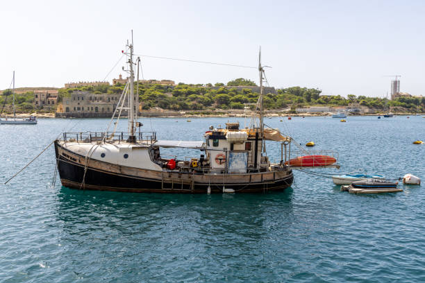 Sliema, Malta - September 22, 2023: A fishing boat in the water in Sliema, Malta