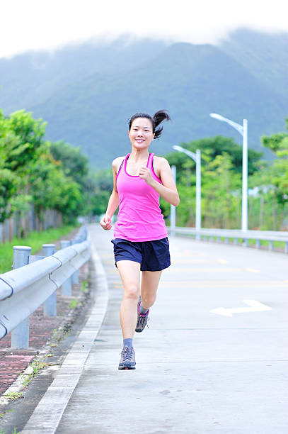 istock young asian woman running 176698644