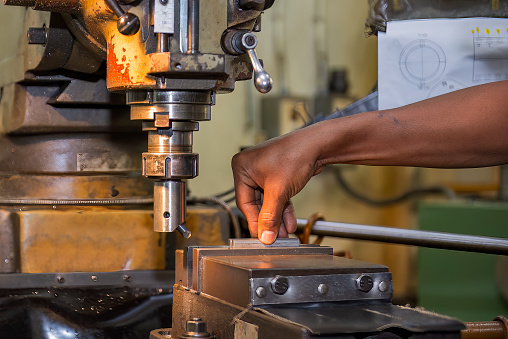 The machine operator setup the NC milling machine for boring process. The NC milling machine setup process by machine operator.