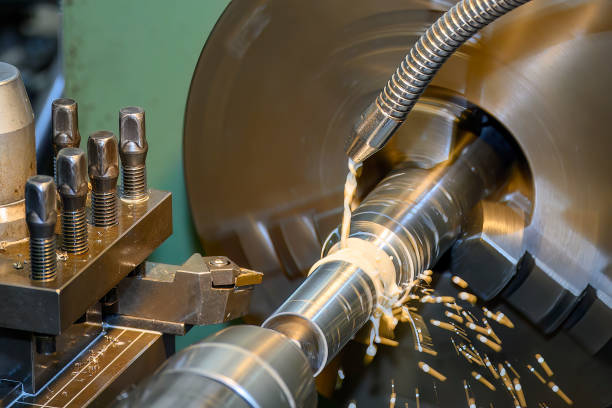 The lathe machine finish cut  metal shaft parts with liquid coolant method. stock photo