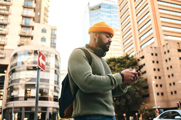 istock City, phone and man typing, walking and check email, mobile communication or app notification on morning journey. Smartphone, connectivity and person contact social media user on street, road or trip 1767008427
