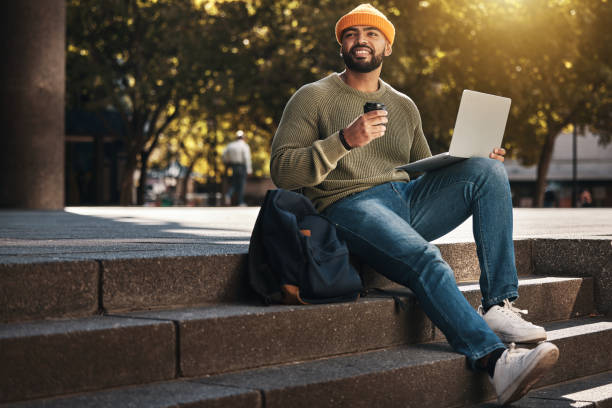 istock Student, laptop and thinking outdoor on coffee break, e learning and online education ideas or inspiration in park. African man on college, university or school campus for studying and happy vision 1767008441